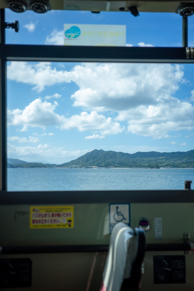 窓枠の向こうに、海と白い雲。